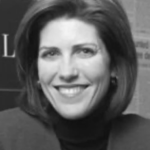 Margie Reedy - Smiling woman with shoulder-length hair wearing a black turtleneck.